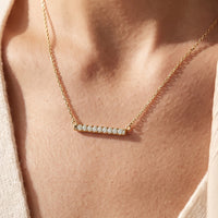 14K Yellow Gold 1/4 CTW Lab-Grown Diamond French-Set Bar 18" Necklace worn by a model