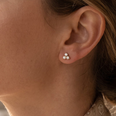 14K Yellow Gold 1/4 CTW Lab-Grown Diamond Three-Stone Earrings worn by a model