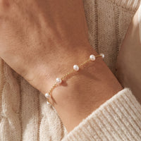 14K Yellow Gold Cultured White Freshwater Pearl 5-Station 7" Bracelet worn by a model