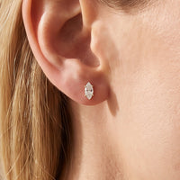 14K Yellow Gold 1/8 CTW Natural Diamond Earrings worn by a model
