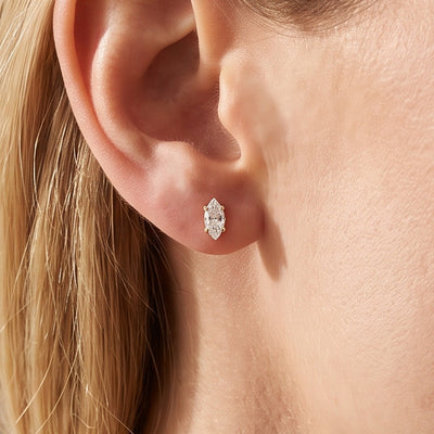 14K Yellow Gold 1/8 CTW Natural Diamond Earrings worn by a model