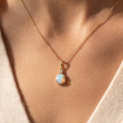 14K Yellow Gold 6x4 mm Natural Ethiopian Opal & .015 CT Natural Diamond 16-18" Necklace worn by a model